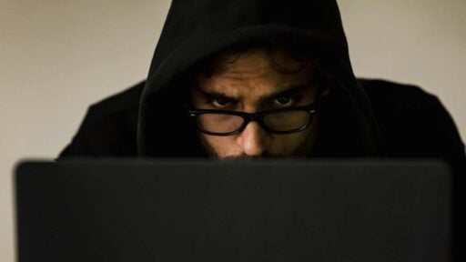 a hacker watching laptop screen