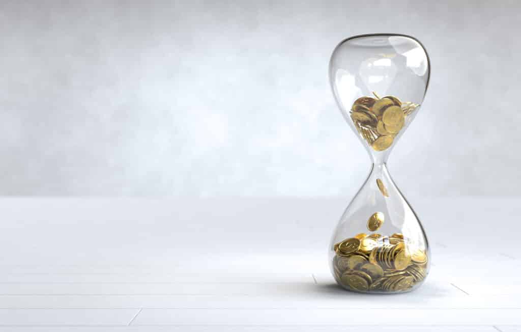 gold coin hourglass time is money concept