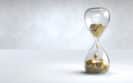 gold coin hourglass time is money concept